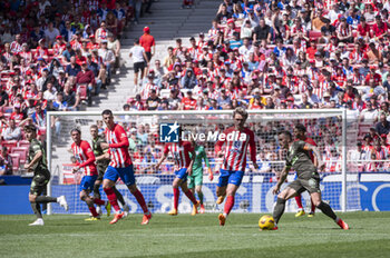 2024-04-13 - Aleix Garcia of Girona FC (R) seen in action with the ball during the La Liga EA Sports football match between Atletico Madrid and Girona FC at Estadio Civitas Metropolitano on April 13, 2024 in Madrid, Spain. - ATLETICO MADRID VS GIRONA - SPANISH LA LIGA - SOCCER