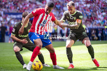 2024-04-13 - Samuel Lino of Atletico Madrid (C) seen in action with the ball against Aleix Garcia of Girona FC (R) during the La Liga EA Sports football match between Atletico Madrid and Girona FC at Estadio Civitas Metropolitano on April 13, 2024 in Madrid, Spain. - ATLETICO MADRID VS GIRONA - SPANISH LA LIGA - SOCCER