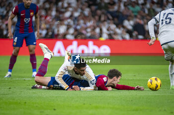 2024-04-21 - MADRID, SPAIN - APRIL 21: Jude Bellingham of Real Madrid (L) seen on the ground with Andreas Christensen of FC Barcelona (R) during the La Liga EA Sports 2023/24 football match between Real Madrid vs FC Barcelona at Estadio Santiago Bernabeu on April 21, 2024 in Madrid, Spain. - REAL MADRID VS FC BARCELONA - SPANISH LA LIGA - SOCCER