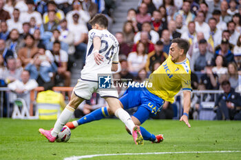 2024-05-04 - MADRID, SPAIN - MAY 04: Arda Guler of Real Madrid (L) seen in action with the ball against Victor Chust of Cadiz CF (R) during the La Liga EA Sports 2023/24 football match between Real Madrid vs Cadiz CF at Estadio Santiago Bernabeu on May 04, 2024 in Madrid, Spain. - REAL MADRID VS CADIZ - SPANISH LA LIGA - SOCCER