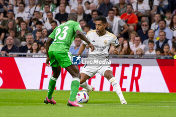 2024-05-25 - Rodrygo Silva de Goes of Real Madrid (R) in action with the ball against Youssouf Sabaly of Real Betis (L) during the La Liga EA Sports 2023/24 football match between Real Madrid vs Real Betis at Estadio Santiago Bernabeu on May 25, 2024 in Madrid, Spain. - REAL MADRID VS REAL BETIS - SPANISH LA LIGA - SOCCER