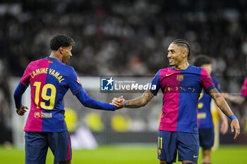 2024-10-26 - Lamine Yamal of FC Barcelona celebrates a goal 0-3 with Raphael Dias "Raphinha" during the Spanish championship La Liga football match between Real Madrid CF and FC Barcelona on 26 October 2024 at Santiago Bernabeu stadium in Madrid, Spain - FOOTBALL - SPANISH CHAMP - REAL MADRID V FC BARCELONA - SPANISH LA LIGA - SOCCER