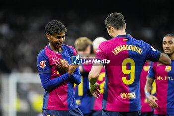 2024-10-26 - Lamine Yamal of FC Barcelona celebrates a goal 0-3 with Robert Lewandowski during the Spanish championship La Liga football match between Real Madrid CF and FC Barcelona on 26 October 2024 at Santiago Bernabeu stadium in Madrid, Spain - FOOTBALL - SPANISH CHAMP - REAL MADRID V FC BARCELONA - SPANISH LA LIGA - SOCCER