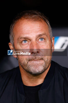 2024-10-26 - Hansi Flick, head coach of FC Barcelona during the Spanish championship La Liga football match between Real Madrid CF and FC Barcelona on 26 October 2024 at Santiago Bernabeu stadium in Madrid, Spain - FOOTBALL - SPANISH CHAMP - REAL MADRID V FC BARCELONA - SPANISH LA LIGA - SOCCER