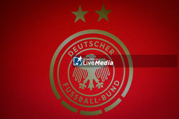 2024-02-22 - Illustration of the official logo of the German women's football team during the press conference on February 22, 2024 prior to the UEFA Women's Nations League 2024, Semi-finals football match between France and Germany on February 23, 2024 at Groupama stadium in Decines-Charpieu near Lyon, France - FOOTBALL - WOMEN'S NATIONS LEAGUE - FRANCE V GERMANY - TRAINING AND PRESS CONFERENCE - UEFA NATIONS LEAGUE - SOCCER