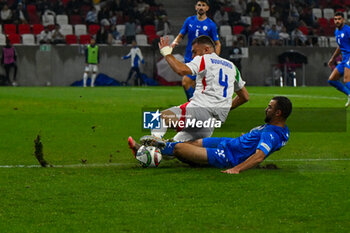 2024-09-09 - Alessandro Buongiorno (Italy) in action against Denny Gropper (Israel) during the UEFA Nations League match between Italy vs. Israele on 9th September 2024 at the Bozsik Arena stadium in Budapest, Hungary - ISRAEL VS ITALY - UEFA NATIONS LEAGUE - SOCCER