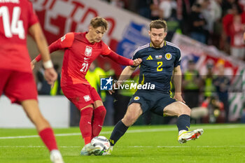 2024-09-05 - Anthony Ralston of Scotland blocks the cross of Nicola Zalewski of Poland during the UEFA Nations League match between Scotland and Poland. The National Stadium, Hampden Park, Glasgow, Scotland. 05/09/2024. Photo Colin Poultney /ProSportsImages / DPPI - FOOTBALL - UEFA NATIONS LEAGUE - SCOTLAND V POLAND - UEFA NATIONS LEAGUE - SOCCER