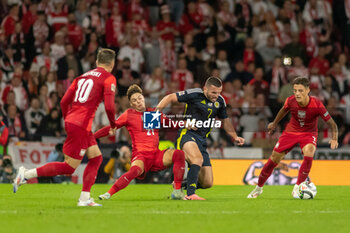 2024-09-05 - Nicola Zalewski of Poland stretches to get the ball from John McGinn of Scotland during the UEFA Nations League match between Scotland and Poland. The National Stadium, Hampden Park, Glasgow, Scotland. 05/09/2024. Photo Colin Poultney /ProSportsImages / DPPI - FOOTBALL - UEFA NATIONS LEAGUE - SCOTLAND V POLAND - UEFA NATIONS LEAGUE - SOCCER