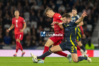 2024-09-05 - Krzysztof Piątek of Poland & Grant Hanley of Scotland during the UEFA Nations League match between Scotland and Poland. The National Stadium, Hampden Park, Glasgow, Scotland. 05/09/2024. Photo Colin Poultney /ProSportsImages / DPPI - FOOTBALL - UEFA NATIONS LEAGUE - SCOTLAND V POLAND - UEFA NATIONS LEAGUE - SOCCER