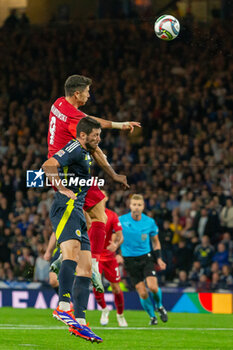 2024-09-05 - Robert Lewandowski of Poland wins a header against Grant Hanley of Scotland during the UEFA Nations League match between Scotland and Poland. The National Stadium, Hampden Park, Glasgow, Scotland. 05/09/2024. Photo Colin Poultney /ProSportsImages / DPPI - FOOTBALL - UEFA NATIONS LEAGUE - SCOTLAND V POLAND - UEFA NATIONS LEAGUE - SOCCER