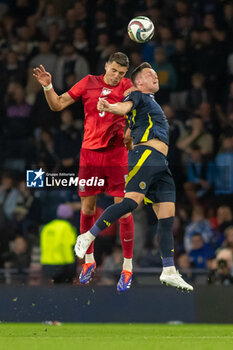 2024-09-05 - Jan Bednarek of Poland challenges Lawrence Shankland of Scotland during the UEFA Nations League match between Scotland and Poland. The National Stadium, Hampden Park, Glasgow, Scotland. 05/09/2024. Photo Colin Poultney /ProSportsImages / DPPI - FOOTBALL - UEFA NATIONS LEAGUE - SCOTLAND V POLAND - UEFA NATIONS LEAGUE - SOCCER