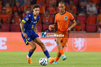 2024-09-07 - Denis Huseinbasic of Bosnia and Herzegovina battles for the ball with Xavi Simons of Netherland during the UEFA Nations League match between Netherlands and Bosnia & Herzegovina at Philips Stadion on September 7, 2024 in Eindhoven, Netherlands - FOOTBALL - NATIONS LEAGUE - NETHERLANDS V BOSNIA - UEFA NATIONS LEAGUE - SOCCER