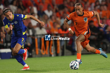 2024-09-07 - Xavi Simons of Netherlands runs with the ball during the UEFA Nations League match between Netherlands and Bosnia & Herzegovina at Philips Stadion on September 7, 2024 in Eindhoven, Netherlands - FOOTBALL - NATIONS LEAGUE - NETHERLANDS V BOSNIA - UEFA NATIONS LEAGUE - SOCCER