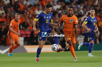 2024-09-07 - Ryan Gravenberch of Netherlands battles for the ball with his team mates Armin Gigovic of Bosnia and Herzegovina during the UEFA Nations League match between Netherlands and Bosnia & Herzegovina at Philips Stadion on September 7, 2024 in Eindhoven, Netherlands - FOOTBALL - NATIONS LEAGUE - NETHERLANDS V BOSNIA - UEFA NATIONS LEAGUE - SOCCER