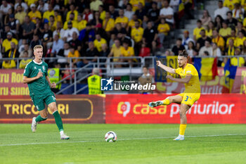 2024-09-09 - Radu Dragusin of Romania passing the ball while under attack from Armandas Kucys of Lithuania during the UEFA Nations League, Group stage, League C, Group C2, football match between Romania and Lithuania on 9 September 2024 at Stadionul Steaua in Bucharest, Romania - FOOTBALL - UEFA NATIONS LEAGUE - ROMANIA V LITHUANIA - UEFA NATIONS LEAGUE - SOCCER