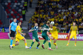 2024-09-09 - Andrei Ratiu of Romania fighting for the ball with Vykintas Slivka of Lithuania during the UEFA Nations League, Group stage, League C, Group C2, football match between Romania and Lithuania on 9 September 2024 at Stadionul Steaua in Bucharest, Romania - FOOTBALL - UEFA NATIONS LEAGUE - ROMANIA V LITHUANIA - UEFA NATIONS LEAGUE - SOCCER