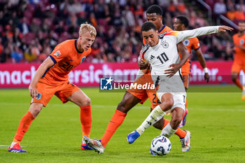 2024-09-10 - Jamal Musiala of Germany battles for the ball with Denzel Dumfries of Netherlands during the UEFA Nations League 2024/2025 League A Group 3 match between Netherlands and Germany at Johan Cruijff ArenA on September 10, 2024 in Amsterdam, Netherlands. Photo Andre Weening/ Orange Pictures / DPPI - FOOTBALL - NATIONS LEAGUE - NETHERLANDS V GERMANY - UEFA NATIONS LEAGUE - SOCCER