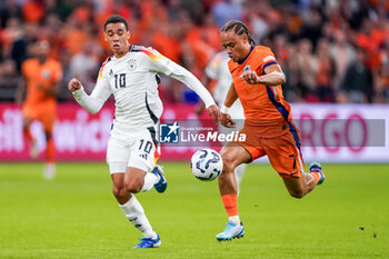 2024-09-10 - Xavi Simons of Netherlands is challenged by Jamal Musiala of Germany during the UEFA Nations League 2024/2025 League A Group 3 match between Netherlands and Germany at Johan Cruijff ArenA on September 10, 2024 in Amsterdam, Netherlands. Photo Andre Weening/ Orange Pictures / DPPI - FOOTBALL - NATIONS LEAGUE - NETHERLANDS V GERMANY - UEFA NATIONS LEAGUE - SOCCER