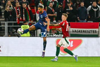 2024-10-11 - Cody Gakpo (Netherlands) in action against Bendeguz Bolla (Hungary) during the UEFA Nations League match between Hungary vs. Holland on 11th October 2024 at the Puskas Arena stadium in Budapest, Hungary - HUNGARY VS NETHERLANDS - UEFA NATIONS LEAGUE - SOCCER