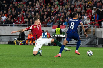 2024-10-11 - Tamas Nikitscher (Hungary) in action against Ryan Gravenberch (Netherlands) during the UEFA Nations League match between Hungary vs. Holland on 11th October 2024 at the Puskas Arena stadium in Budapest, Hungary - HUNGARY VS NETHERLANDS - UEFA NATIONS LEAGUE - SOCCER