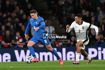 2024-10-10 - Christos Tzolis (8) of Greece and Trent Alexander-Arnold (2) of England during the UEFA Nations League, League B, Group B2 football match between England and Greece on 10 October 2024 at Wembley Stadium in London, England - FOOTBALL - UEFA NATIONS LEAGUE - ENGLAND V GREECE - UEFA NATIONS LEAGUE - SOCCER