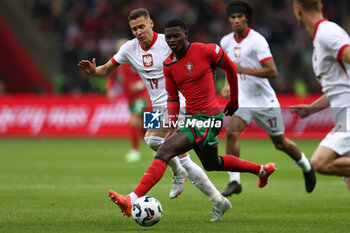 2024-10-12 - Przemyslaw Frankowski of Poland and Nuno Mendes of Portugal during the UEFA Nations League, League A, Group A1 football match between Poland and Portugal on 12 October 2024 at PGE Narodowy in Warsaw, Poland - FOOTBALL - UEFA NATIONS LEAGUE - POLAND V PORTUGAL - UEFA NATIONS LEAGUE - SOCCER