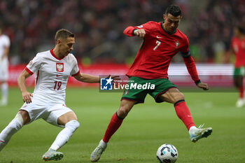 2024-10-12 - Przemyslaw Frankowski of Poland and Cristiano Ronaldo of Portugal during the UEFA Nations League, League A, Group A1 football match between Poland and Portugal on 12 October 2024 at PGE Narodowy in Warsaw, Poland - FOOTBALL - UEFA NATIONS LEAGUE - POLAND V PORTUGAL - UEFA NATIONS LEAGUE - SOCCER