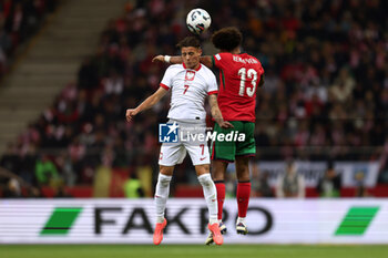 2024-10-12 - Kacper Urbanski of Poland and Renato Veiga of Portugal during the UEFA Nations League, League A, Group A1 football match between Poland and Portugal on 12 October 2024 at PGE Narodowy in Warsaw, Poland - FOOTBALL - UEFA NATIONS LEAGUE - POLAND V PORTUGAL - UEFA NATIONS LEAGUE - SOCCER