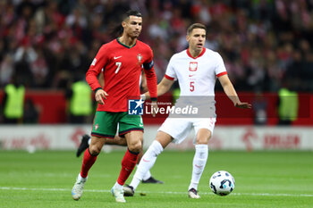 2024-10-12 - Cristiano Ronaldo of Portugal and Jan Bednarek of Poland during the UEFA Nations League, League A, Group A1 football match between Poland and Portugal on 12 October 2024 at PGE Narodowy in Warsaw, Poland - FOOTBALL - UEFA NATIONS LEAGUE - POLAND V PORTUGAL - UEFA NATIONS LEAGUE - SOCCER