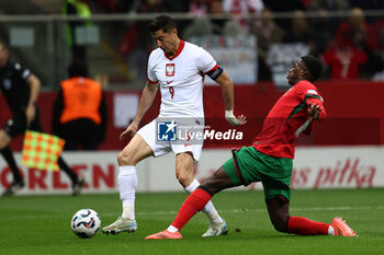 2024-10-12 - Robert Lewandowski of Poland and Nuno Mendes of Portugal during the UEFA Nations League, League A, Group A1 football match between Poland and Portugal on 12 October 2024 at PGE Narodowy in Warsaw, Poland - FOOTBALL - UEFA NATIONS LEAGUE - POLAND V PORTUGAL - UEFA NATIONS LEAGUE - SOCCER