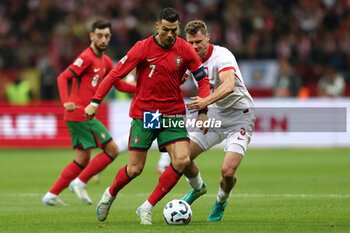 2024-10-12 - Cristiano Ronaldo of Portugal and Pawel Dawidowicz of Poland during the UEFA Nations League, League A, Group A1 football match between Poland and Portugal on 12 October 2024 at PGE Narodowy in Warsaw, Poland - FOOTBALL - UEFA NATIONS LEAGUE - POLAND V PORTUGAL - UEFA NATIONS LEAGUE - SOCCER