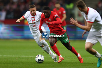 2024-10-12 - Przemyslaw Frankowski of Poland and Nuno Mendes of Portugal during the UEFA Nations League, League A, Group A1 football match between Poland and Portugal on 12 October 2024 at PGE Narodowy in Warsaw, Poland - FOOTBALL - UEFA NATIONS LEAGUE - POLAND V PORTUGAL - UEFA NATIONS LEAGUE - SOCCER