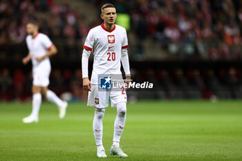 2024-10-12 - Sebastian Szymanski of Poland during the UEFA Nations League, League A, Group A1 football match between Poland and Portugal on 12 October 2024 at PGE Narodowy in Warsaw, Poland - FOOTBALL - UEFA NATIONS LEAGUE - POLAND V PORTUGAL - UEFA NATIONS LEAGUE - SOCCER