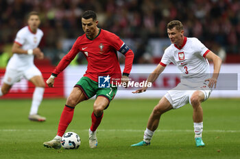 2024-10-12 - Cristiano Ronaldo of Portugal and Pawel Dawidowicz of Poland during the UEFA Nations League, League A, Group A1 football match between Poland and Portugal on 12 October 2024 at PGE Narodowy in Warsaw, Poland - FOOTBALL - UEFA NATIONS LEAGUE - POLAND V PORTUGAL - UEFA NATIONS LEAGUE - SOCCER