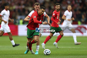 2024-10-12 - Cristiano Ronaldo of Portugal and Pawel Dawidowicz of Poland during the UEFA Nations League, League A, Group A1 football match between Poland and Portugal on 12 October 2024 at PGE Narodowy in Warsaw, Poland - FOOTBALL - UEFA NATIONS LEAGUE - POLAND V PORTUGAL - UEFA NATIONS LEAGUE - SOCCER