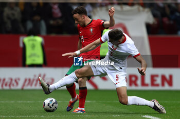 2024-10-12 - Diogo Jota of Portugal and Jan Bednarek of Poland during the UEFA Nations League, League A, Group A1 football match between Poland and Portugal on 12 October 2024 at PGE Narodowy in Warsaw, Poland - FOOTBALL - UEFA NATIONS LEAGUE - POLAND V PORTUGAL - UEFA NATIONS LEAGUE - SOCCER