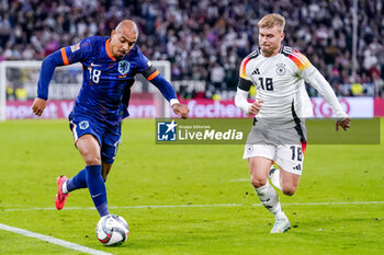 2024-10-14 - Donyell Malen of Netherlands is challenged by Maximilian Mittelstädt of Germany during the UEFA Nations League, League A, Group 3 football match between Germany and Netherlands on October 14, 2024 at Allianz Arena in Munich, Germany - FOOTBALL - UEFA NATIONS LEAGUE - GERMANY V NETHERLANDS - UEFA NATIONS LEAGUE - SOCCER