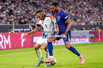 2024-10-14 - Jamie Leweling of Germany battles for the ball with Ryan Gravenberch of Netherlands during the UEFA Nations League, League A, Group 3 football match between Germany and Netherlands on October 14, 2024 at Allianz Arena in Munich, Germany - FOOTBALL - UEFA NATIONS LEAGUE - GERMANY V NETHERLANDS - UEFA NATIONS LEAGUE - SOCCER