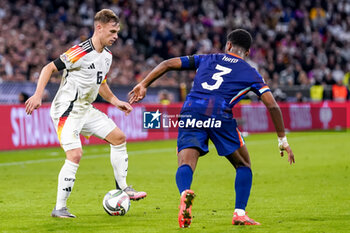 2024-10-14 - Joshua Kimmich of Germany is challenged by Jorrel Hato of Netherlands during the UEFA Nations League, League A, Group 3 football match between Germany and Netherlands on October 14, 2024 at Allianz Arena in Munich, Germany - FOOTBALL - UEFA NATIONS LEAGUE - GERMANY V NETHERLANDS - UEFA NATIONS LEAGUE - SOCCER