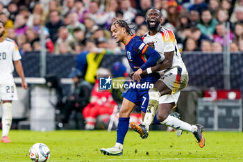 2024-10-14 - Xavi Simons of Netherlands battles for the ball with Antonio Rüdiger of Germany during the UEFA Nations League, League A, Group 3 football match between Germany and Netherlands on October 14, 2024 at Allianz Arena in Munich, Germany - FOOTBALL - UEFA NATIONS LEAGUE - GERMANY V NETHERLANDS - UEFA NATIONS LEAGUE - SOCCER