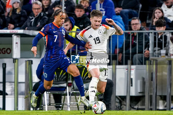 2024-10-14 - Xavi Simons of Netherlands battles for the ball with Angelo Stiller of Germany during the UEFA Nations League, League A, Group 3 football match between Germany and Netherlands on October 14, 2024 at Allianz Arena in Munich, Germany - FOOTBALL - UEFA NATIONS LEAGUE - GERMANY V NETHERLANDS - UEFA NATIONS LEAGUE - SOCCER