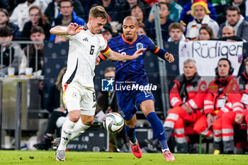 2024-10-14 - Joshua Kimmich of Germany battles for the ball with Donyell Malen of Netherlands during the UEFA Nations League, League A, Group 3 football match between Germany and Netherlands on October 14, 2024 at Allianz Arena in Munich, Germany - FOOTBALL - UEFA NATIONS LEAGUE - GERMANY V NETHERLANDS - UEFA NATIONS LEAGUE - SOCCER