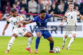 2024-10-14 - Jorrel Hato of Netherlands battles for the ball with Serge Gnabry of Germany during the UEFA Nations League, League A, Group 3 football match between Germany and Netherlands on October 14, 2024 at Allianz Arena in Munich, Germany - FOOTBALL - UEFA NATIONS LEAGUE - GERMANY V NETHERLANDS - UEFA NATIONS LEAGUE - SOCCER