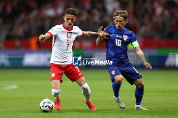 13/10/2024 - Kacper Urbanski of Poland and Luka Modric of Croatia during the UEFA Nations League, League A, Group A1 football match between Poland and Croatia on 15 October 2024 at PGE Narodowy stadium in Warsaw, Poland - FOOTBALL - UEFA NATIONS LEAGUE - POLAND V CROATIA - UEFA NATIONS LEAGUE - CALCIO