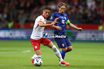 13/10/2024 - Kacper Urbanski of Poland and Luka Modric of Croatia during the UEFA Nations League, League A, Group A1 football match between Poland and Croatia on 15 October 2024 at PGE Narodowy stadium in Warsaw, Poland - FOOTBALL - UEFA NATIONS LEAGUE - POLAND V CROATIA - UEFA NATIONS LEAGUE - CALCIO