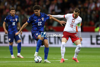 2024-10-15 - Igor Matanovic of Croatia and Piotr Zielinski of Poland during the UEFA Nations League, League A, Group A1 football match between Poland and Croatia on 15 October 2024 at PGE Narodowy stadium in Warsaw, Poland - FOOTBALL - UEFA NATIONS LEAGUE - POLAND V CROATIA - UEFA NATIONS LEAGUE - SOCCER