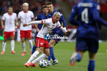 2024-10-15 - Ivan Perisic of Croatia and Jakub Kaminski of Poland during the UEFA Nations League, League A, Group A1 football match between Poland and Croatia on 15 October 2024 at PGE Narodowy stadium in Warsaw, Poland - FOOTBALL - UEFA NATIONS LEAGUE - POLAND V CROATIA - UEFA NATIONS LEAGUE - SOCCER