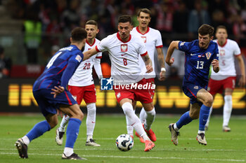 2024-10-15 - Jakub Moder of Poland and Petar Sucic of Croatia during the UEFA Nations League, League A, Group A1 football match between Poland and Croatia on 15 October 2024 at PGE Narodowy stadium in Warsaw, Poland - FOOTBALL - UEFA NATIONS LEAGUE - POLAND V CROATIA - UEFA NATIONS LEAGUE - SOCCER