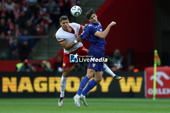 2024-10-15 - Jan Bednarek of Poland and Igor Matanovic of Croatia during the UEFA Nations League, League A, Group A1 football match between Poland and Croatia on 15 October 2024 at PGE Narodowy stadium in Warsaw, Poland - FOOTBALL - UEFA NATIONS LEAGUE - POLAND V CROATIA - UEFA NATIONS LEAGUE - SOCCER