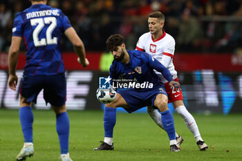 2024-10-15 - Josko Gvardiol of Croatia and Sebastian Szymanski of Poland during the UEFA Nations League, League A, Group A1 football match between Poland and Croatia on 15 October 2024 at PGE Narodowy stadium in Warsaw, Poland - FOOTBALL - UEFA NATIONS LEAGUE - POLAND V CROATIA - UEFA NATIONS LEAGUE - SOCCER